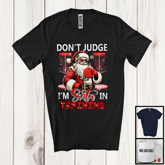 MacnyStore - Don't Judge I'm Santa In Training; Sarcastic Christmas Disc Golf Santa; Snowing X-mas Family T-Shirt