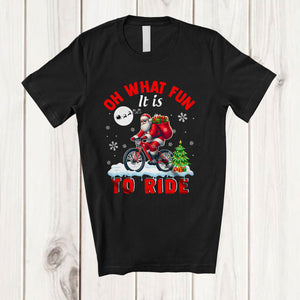 MacnyStore - Oh What Fun It Is To Ride; Amusing Christmas Santa Bicycle Rider; X-mas Tree Snowing T-Shirt