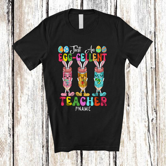 MacnyStore - Personalized Custom Name Just An Egg-cellent Teacher; Joyful Easter Excellent 3 Bunnies Pencils T-Shirt