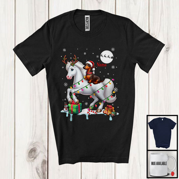 MacnyStore - Personalized Custom Name Santa Dachshund Riding Reindeer Horse; Adorable Christmas Lights Snow T-Shirt