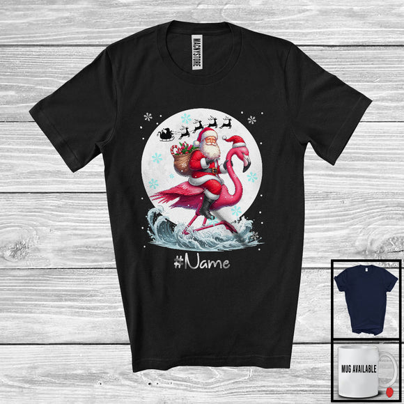 MacnyStore - Personalized Custom Name Santa Riding Flamingo, Merry Christmas Moon Snow Flamingo, X-mas T-Shirt
