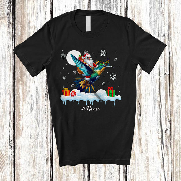 MacnyStore - Personalized Custom Name Santa Riding Hummingbird; Awesome Christmas Snowing Bird; Family T-Shirt