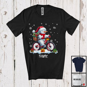 MacnyStore - Personalized Custom Name Snowman Riding Bicycle, Adorable Christmas Rider, X-mas Team T-Shirt
