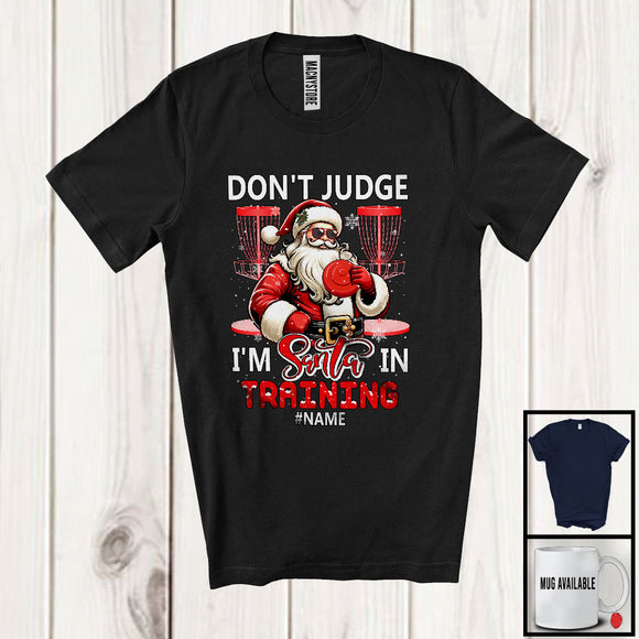 MacnyStore - Personalized Don't Judge Santa In Training; Humorous Christmas Custom Name Disc Golf Santa T-Shirt