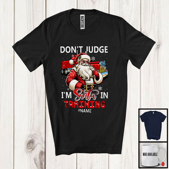 MacnyStore - Personalized Don't Judge Santa In Training; Humorous Christmas Custom Name Trucker Santa T-Shirt