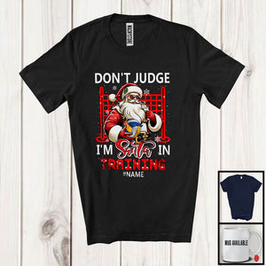 MacnyStore - Personalized Don't Judge Santa In Training; Humorous Christmas Custom Name Volleyball Santa T-Shirt