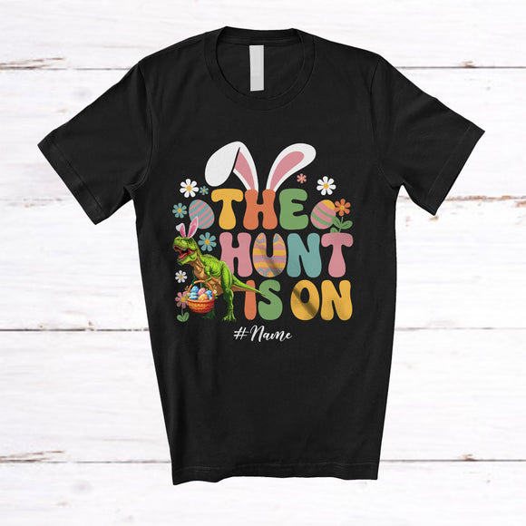 MacnyStore - Personalized The Hunt Is On; Awesome Easter Custom Name T-Rex Hunting Eggs; Groovy Family T-Shirt