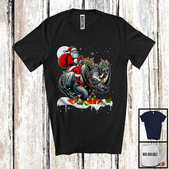 MacnyStore - Santa Riding Rhino Reindeer; Amusing Christmas Lights Santa Rhino Animal; Snowing T-Shirt