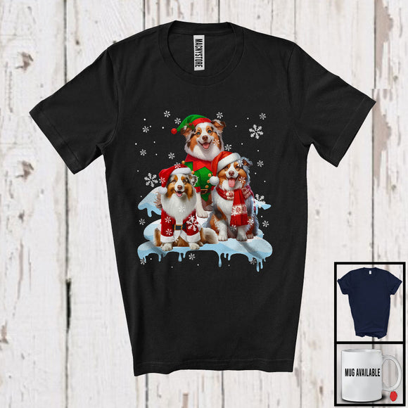 MacnyStore - Three Santa Elf Australian Shepherds On Snow; Adorable Christmas Snowing Dog; Family Group T-Shirt